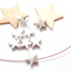 Perles étoiles 11mm en métal argenté par lot de 10